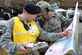 U.S. Air Force Master Sgt. Todd Pluff, 633rd Security Forces Squadron chief of standardization and evaluations, prepares for an exercise with Master Sgt. Nathan Shaw, 633rd SFS Flight chief, at Joint Base Langley- Eustis, Va., Feb. 22, 2017. The exercise was conducted by the 633rd Air Base Wing Inspector General’s office to test how the installation would react to a chemical, biological, radiological, nuclear and explosives emergency. (U.S. Air Force photo/Airman 1st Class Tristian Biese)