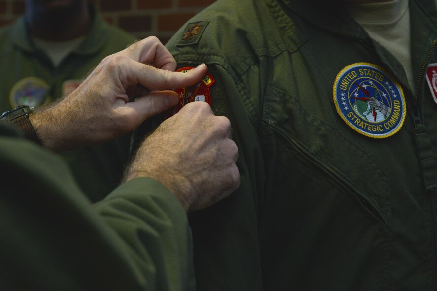 A 740th Missile Squadron operator receives a 48-hour alert pin at Minot Air Force Base, N.D., March 15, 2017. On March 6, a winter storm caused 91st Missile Wing Intercontinental Ballistic Missile operators to stay an extra night until a crew could safely replace them. (U.S. Air Force photo/Airman 1st Class Jessica Weissman)