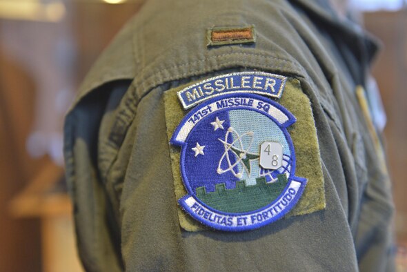 A 741st Missile Squadron operator stands after receiving a 48 hour alert pin at Minot Air Force Base, N.D., March 15, 2017. Operators receive messages from the National Military Command System and respond to messages while driving missile operations. (U.S. Air Force photo/Airman 1st Class Jessica Weissman)