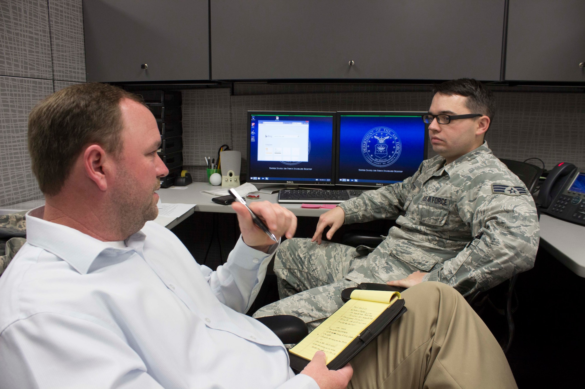 At right, Senior Airman Gentry, water fuel system maintenance planner at the 60th Civil Engineer Squadron at Travis Air Force Base, California, and Samuel "Jason" Schmitz, preventive maintenance program manager at the Air Force Civil Engineer Center, discuss managing the preventive maintenance program using new NexGen IT TRIRIGA software during a recent consulting visit at the base. The software helps develop and manage preventive maintenance schedules and resources for the Air Force. (U.S. Air Force Photo/Susan Lawson)
