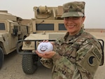 Sgt. Claudia Keit, a Virginia Army National Guard member with the 29th Infantry Division poses with her "Wilson" a stress relief ball at Camp Arifjan, Kuwait, March 11, 2017. Keit is a chemical, biological, radiological and nuclear noncommissioned officer deployed as part of Operation Spartan Shield and is a featured NCO for Women's History Month.