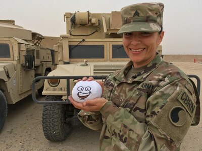 Sgt. Claudia Keit, a Virginia Army National Guard member with the 29th Infantry Division poses with her "Wilson" a stress relief ball at Camp Arifjan, Kuwait, March 11, 2017. Keit is a chemical, biological, radiological and nuclear noncommissioned officer deployed as part of Operation Spartan Shield and is a featured NCO for Women's History Month.