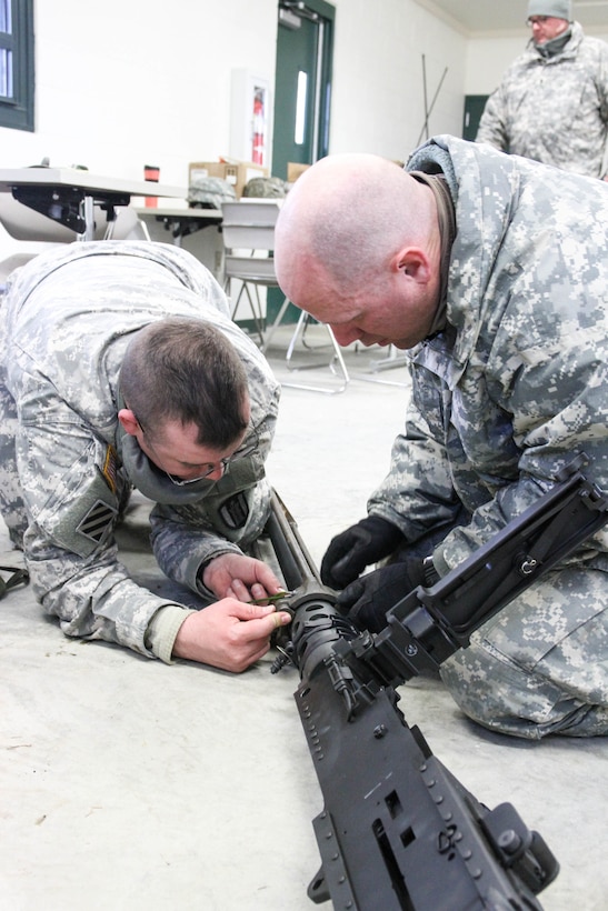 FORT MCCOY, Wis. - U.S. Amy Reserve Sgt. Gereld Moore (left) and Spc. Matthew Wangen, 327th Engineer Company, 416th Theater Engineer Command, attached a blank adapter to an M2 machine gun prior to blank fire during Operation Cold Steel at McCoy, Wis., March 14, 2017. Moore and his team will complete mounted gunnery training with a dump truck. Operation Cold Steel is the U.S. Army Reserve's crew-served weapons qualification and validation exercise to ensure that America's Army Reserve units and soldiers are trained and ready to deploy on short-notice and bring combat-ready and lethal firepower in support of the Army and our joint partners anywhere in the world. (U.S. Army Reserve photo by Staff Sgt. Debralee Best, 84th Training Command)