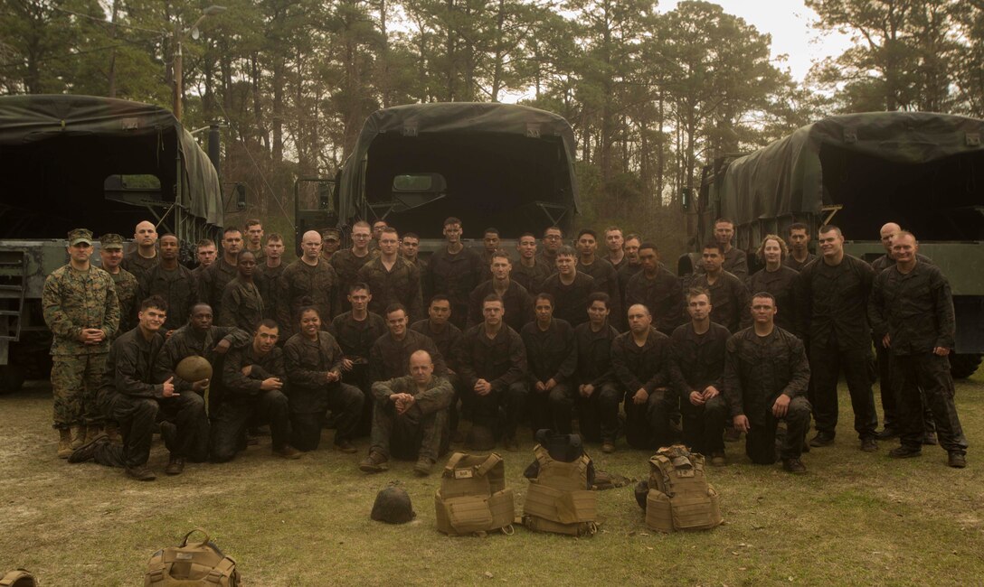Marines gather for a celebratory photo after the completion of the endurance course at the Battle Skills Training School on Camp Lejeune, N.C., March 10, 2017. The course is designed to improve and test Marines on their ability to work together through challenging obstacles. The Marines are with 8th Engineer Support Battalion. (U.S. Marine Corps photo by Pfc. Abrey Liggins)