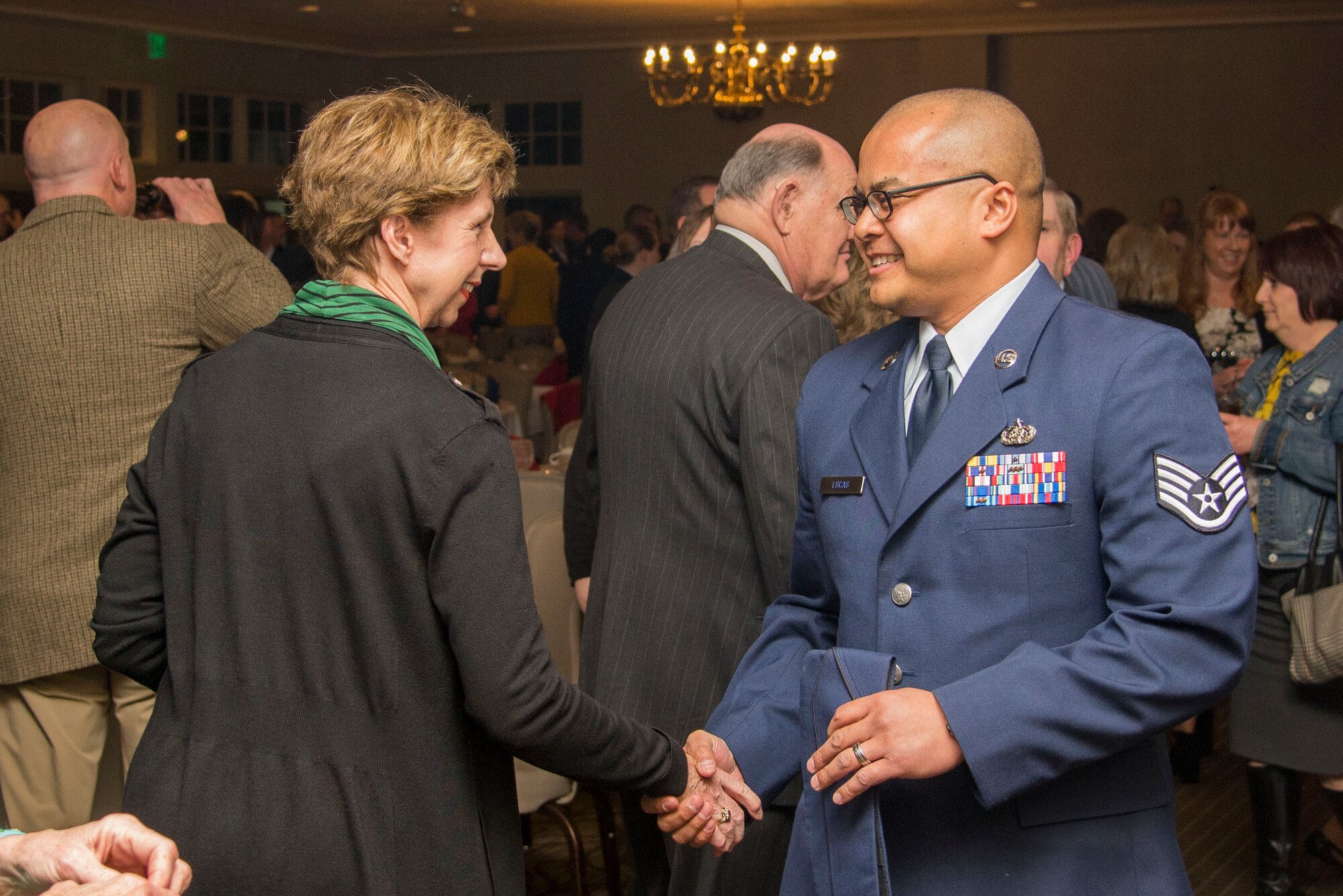 A community member greets Staff Sgt. Christopher Lucas upon arrival at the dinner.