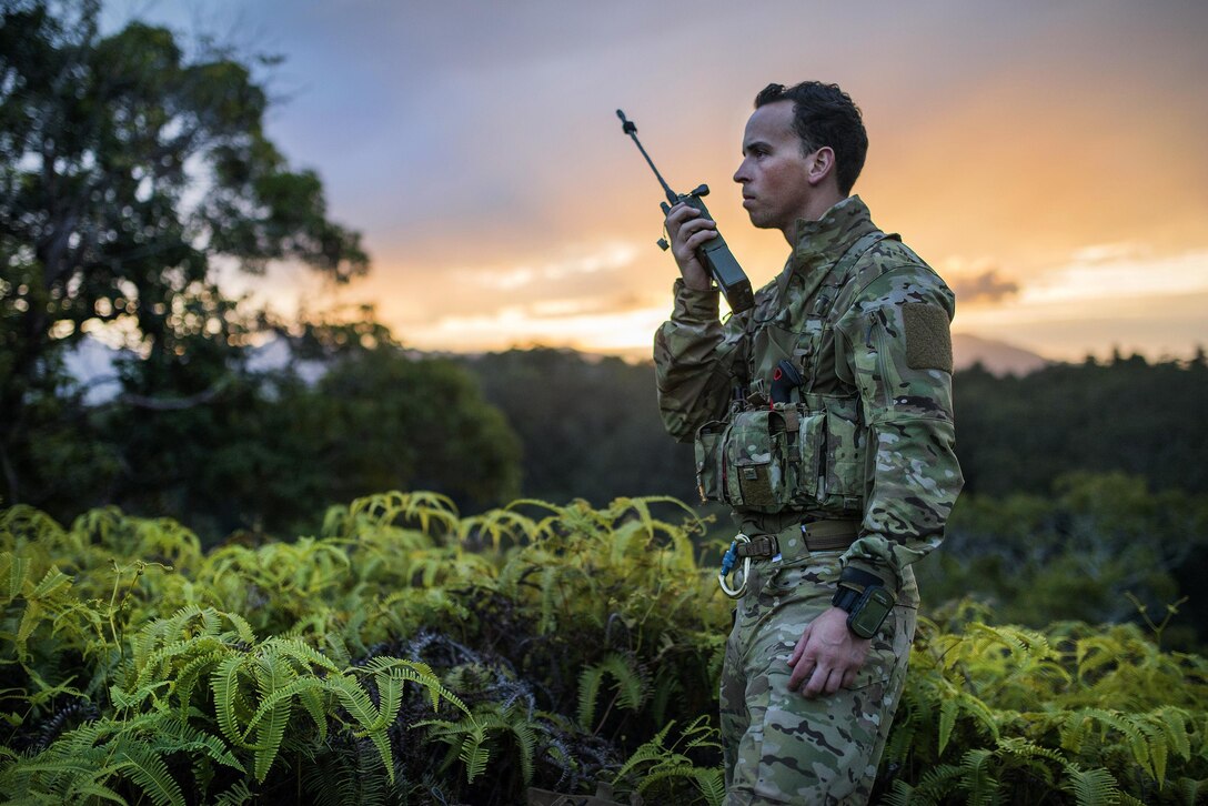 Air Force Senior Airman Jonathan Harvey uses a radio to contact friendly forces during survival training at the Army's Jungle Operations Training Course in Hawaii, March 8, 2017. Harvey is a survival, evasion, resistance and escape specialist assigned to the 106th Rescue Wing. Air National Guard photo by Staff Sgt. Christopher S. Muncy
