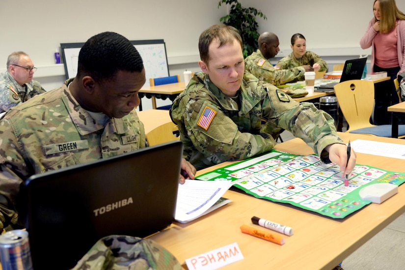 KAISERSLAUTERN, Germany- Sgt. Randall Green, left, and Staff Sgt. Jared McCauley both from the 361st Civil Affairs Brigade, practice Russian with the help of a game that plays recordings of words during a four-day class to learn Russian Wednesday, March 15, 2017. 
(Photo by Lt. Col. Jefferson Wolfe, 7th Mission Support Command Public Affairs Office)