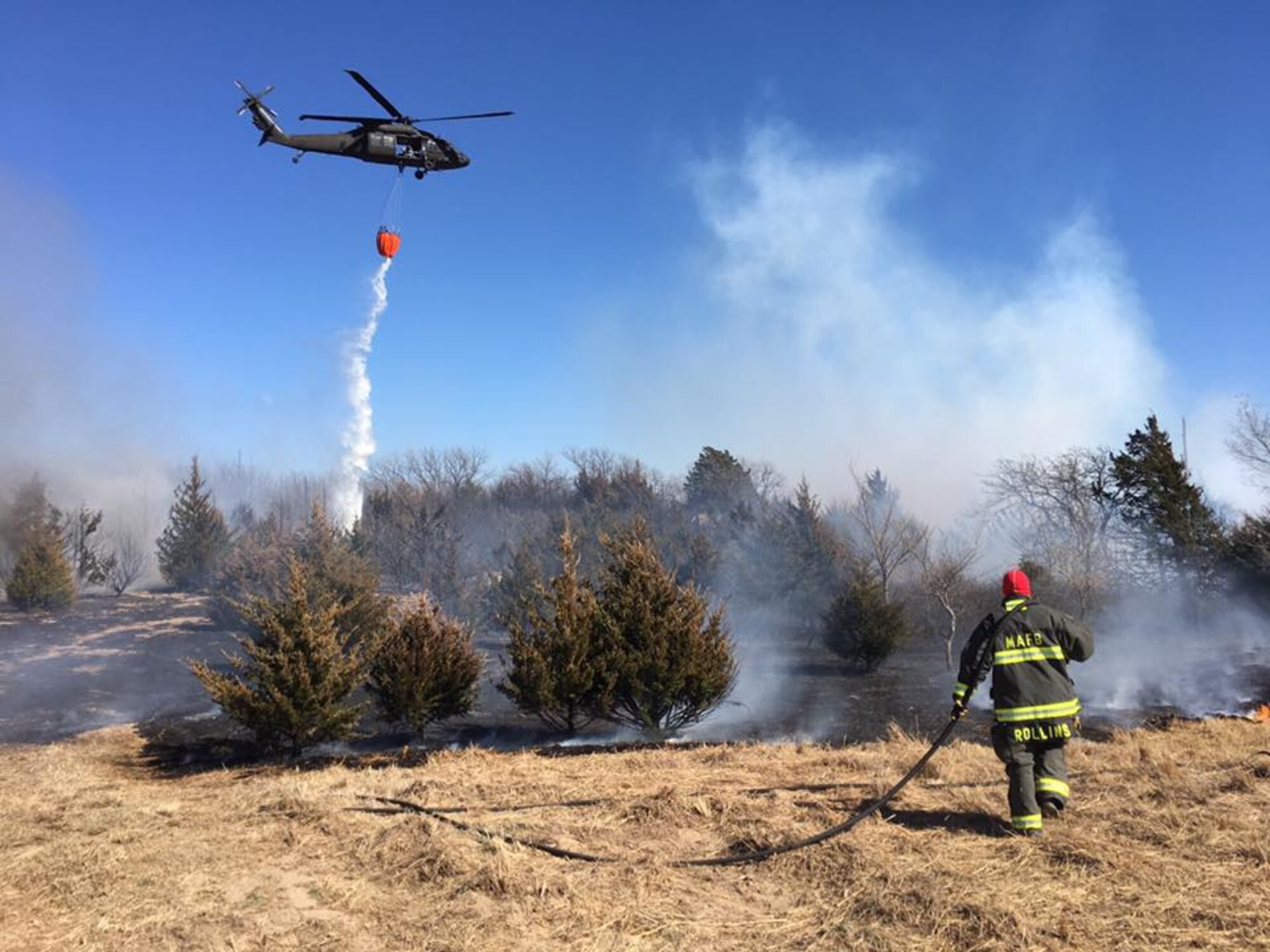 Tech. Sgt. Kyle Rollins, 22nd Civil Engineer Squadron firefighter, contains a wildfire March 7, 2016, in Reno County, Kan. Eighteen firefighters from McConnell Air Force Base responded to the fire to aid the local fire departments. (Courtesy photo)