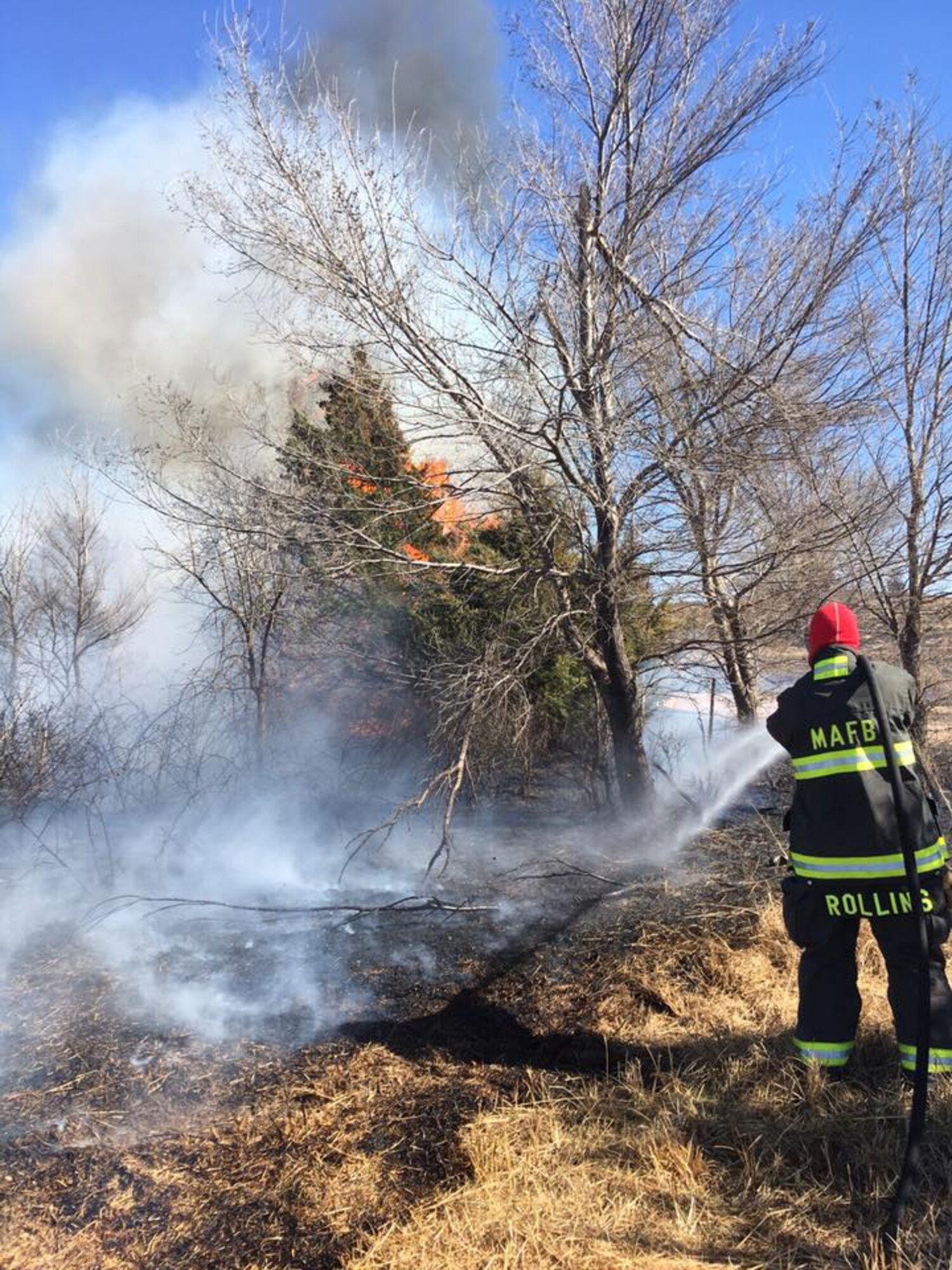 Tech. Sgt. Kyle Rollins, 22nd Civil Engineer Squadron firefighter, battles a wildfire March 7, 2016, in Reno County, Kan. More than 2,000 firefighter from 216 organizations responded to the fires in the area, including 18 from McConnell Air Force Base. (Courtesy photo)