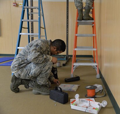 Senior Airman Diego Rojas Rodriguez, 341st Civil Engineer Squadron electrical systems journeyman, browses his electrical equipment March 13, 2017, at Malmstrom Air Force Base, Mont. The electrical team is replacing more than 12,000 lamps on base at nine facilities with LEDs, and they have already completed three of the nine buildings. (U.S. Air Force photo/Airman 1st Class Daniel Brosam)