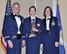 Col. James DeVere, the 302nd Airlift Wing commander (left)and Chief Master Sgt. Vicki Robertson, (right) the 302nd AW command chief, present Maj. Jami Fernandez, 34th Aeromedical Evacuation Squadron, with the 2016 field grade officer of year the award during the annual awards banquet in downtown Colorado Springs, Colorado, March 4, 2017. (U.S. Air Force photo by Staff Sgt. Amber Sorsek)