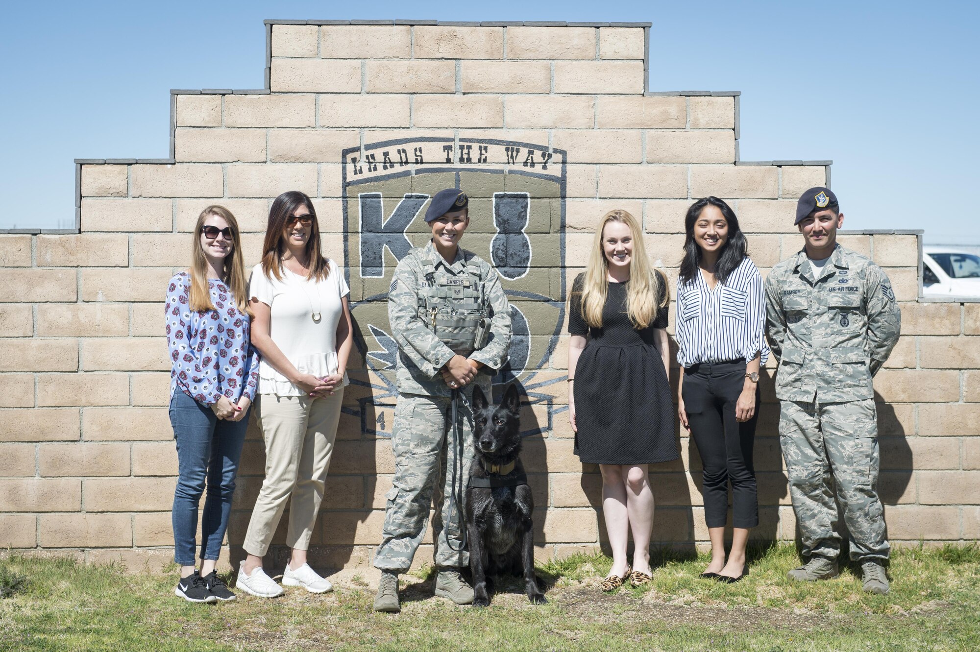 From left: Congressional staffers Alexandria Walker and Cynthia Barile; Staff Sgt. Grace Daniels with Rolf, 412th Security Forces Squadron; staffers Alison Martin and Narah Jayasekera; and Staff Sgt. James Ramsey, 412th SFS; pose for a photo at the 412th SFS Military Working Dog Section March 13. (U.S. Air Force photo by Kyle Larson) 