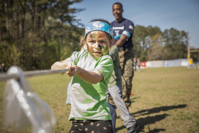 A child participates in tug-of-war during Mini Marines aboard Marine Corps Air Station, Mar. 11. The Marine Corps Community Services event is held to promote a family atmosphere for the children and families of Marines at the air station.