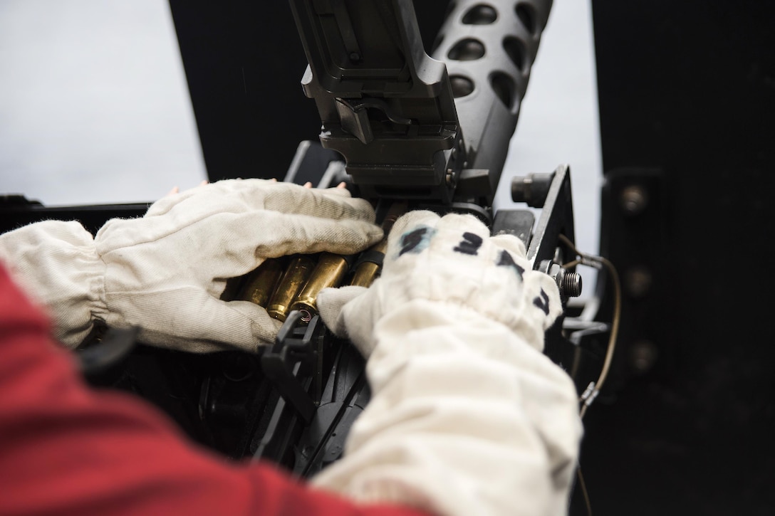 Navy Seaman Yusef Ali Reynolds loads a .50-caliber machine gun during small craft action team training aboard amphibious assault ship USS Bonhomme Richard in the Philippine Sea, March 13, 2017. Reynolds is a gunner’s mate. Navy photo by Seaman Jesse Marquez Magallanes