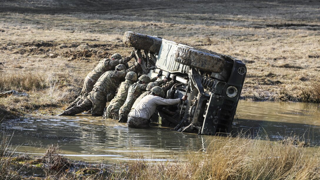 Soldiers push a Humvee during vehicle recovery training as part of Exercise Allied Spirit VI in Hohenfels, Germany, March 14, 2017. Army photo by Sgt. Matthew Hulett