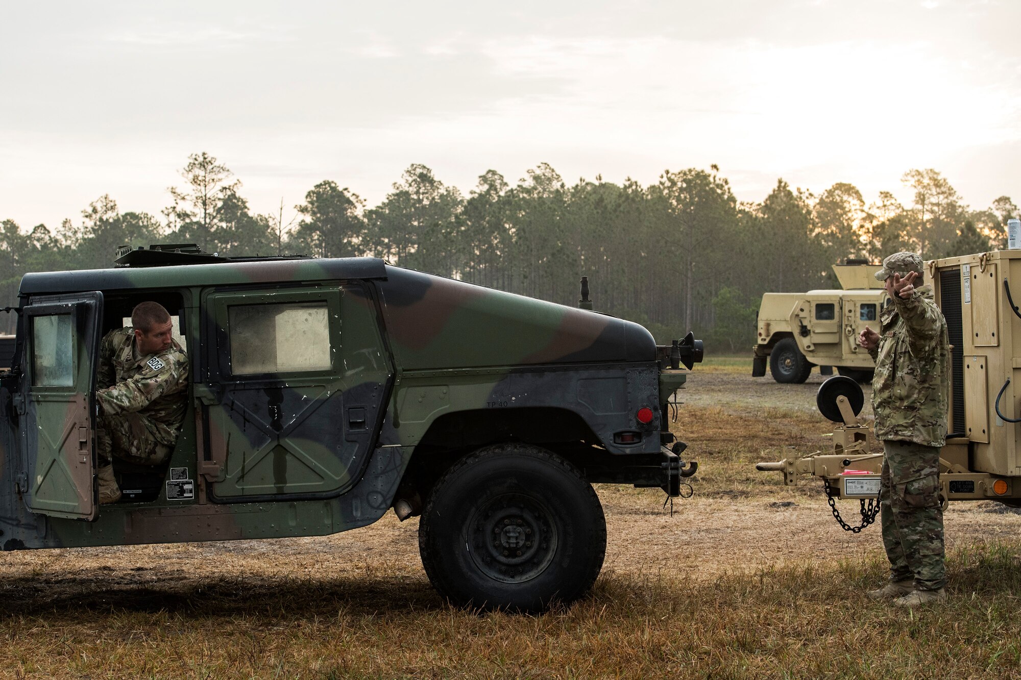 Staff Sgt. Joel Kirtley, 822d Base Defense Squadron NCO in charge of vehicular equipment, backs up a Humvee before connecting it to a generator for transport after a Mission Readiness Exercise, March 13, 2017, at Avon Park Air Force Range, Fla. Throughout the exercise, various missions and scenarios tested the 822d BDS’s ability to adapt and overcome as a team and working vehicles were critical to those missions. (U.S. Air Force photo by Airman 1st Class Janiqua P. Robinson)