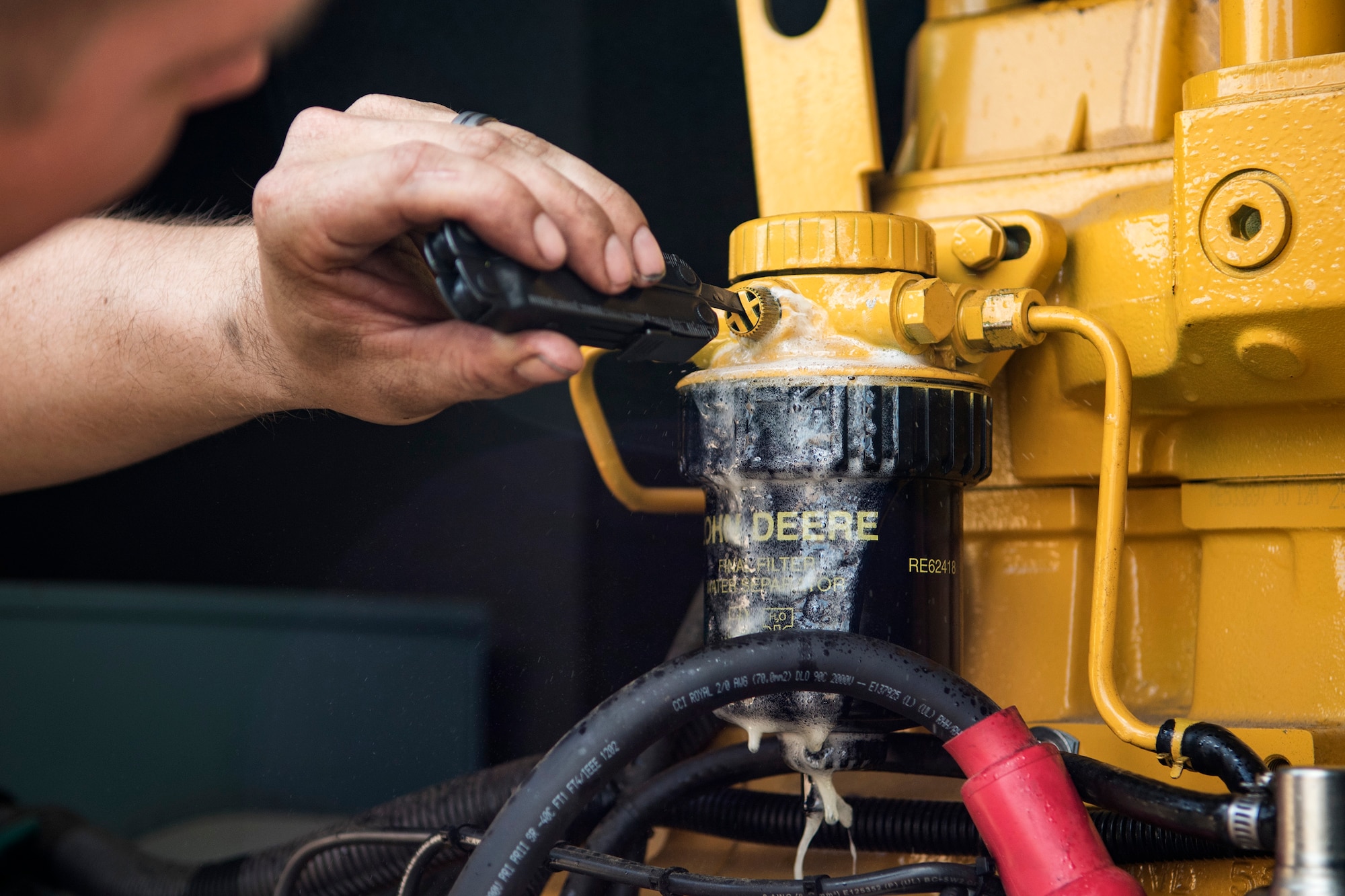 Staff Sgt. Joel Kirtley, 822d Base Defense Squadron NCO in charge of vehicular equipment, finishes repairs on a generator during a Mission Readiness Exercise, March 9, 2017, at Avon Park Air Force Range, Fla. This generator powered the units used for heating or cooling tents where Airmen participating in the exercise would sleep. (U.S. Air Force photo by Airman 1st Class Janiqua P. Robinson)