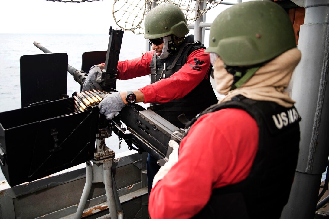 Navy Petty Officer 2nd Class Christopher Womack and Seaman Yomara Ramos Cruz load a .50-caliber machine gun during small craft action team training aboard amphibious assault ship USS Bonhomme Richard in the Philippine Sea, March 13, 2017. Womack and Cruz are gunner’s mates. Navy photo by Seaman Jesse Marquez Magallanes