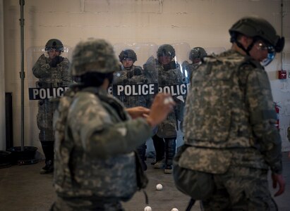 Security forces specialists assigned to the 182nd Security Forces Squadron, Illinois Air National Guard, react to simulated rioters throwing baseballs at them during civil disturbance training in Peoria, Ill., March 4, 2017. The squadron trains in confrontation management as part of the Air National Guard’s mission to be the first choice for homeland operations.