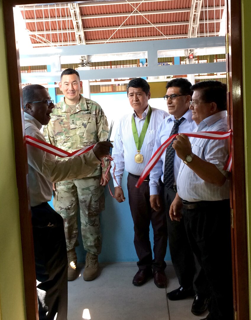 Brian Nichols, U.S. Ambassador to Peru, cuts the ribbon to formally open the Jose Maria Arguedas School, during the school’s inauguration in Aguatyia, Peru, March 13.