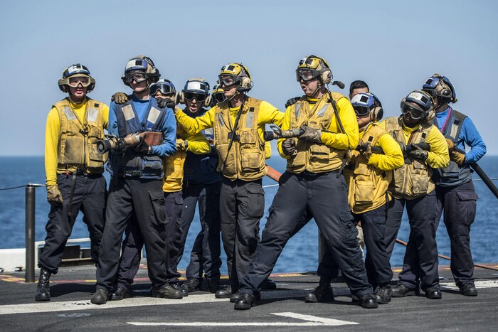 Sailors fight a simulated fire during an aviation fire drill aboard the amphibious assault ship USS Makin Island. Makin Island is deployed in the U.S. 5th Fleet area of operations in support of maritime security operations designed to reassure allies and partners, and preserve the freedom of navigation and the free flow of commerce in the region. Navy photo by MC3 Devin M. Langer