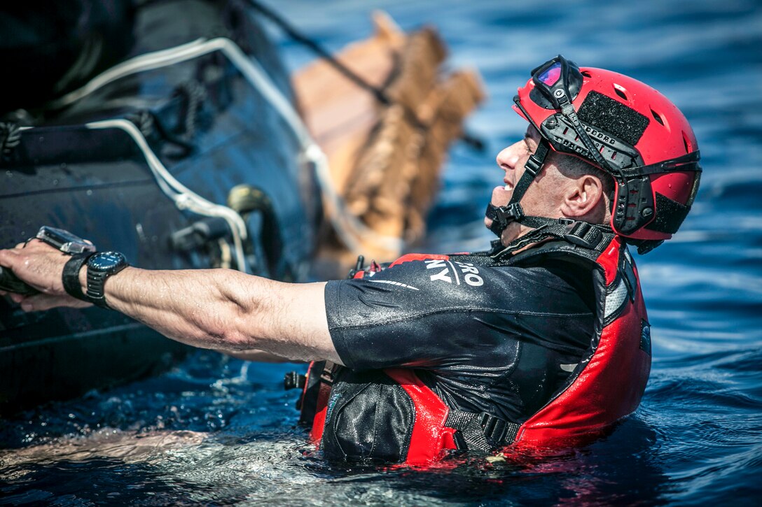 An Air National Guardsman prepares an inflatable boat for dispatch during training near Marine Corps Base Hawaii, March 6, 2017. The training prepared airmen to support and rescue NASA astronauts in the event of Orion spacecraft water landings. Marine Corps photo by Sgt. Brittney Vella