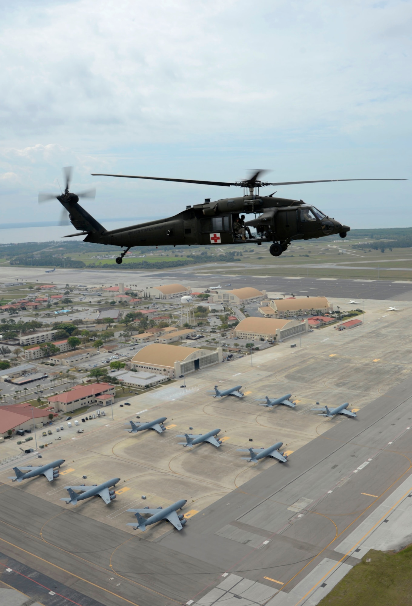 A HH-60 Black Hawk helicopter flies over the airfield during an aeromedical evacuation exercise at MacDill Air Force Base, Fla., March 12, 2017. The exercise compiled knowledge and hands-on training of site acquirement, set up, patient movement, patient care and patient staging. (U.S. Air Force photo by Senior Airman Tori Schultz)