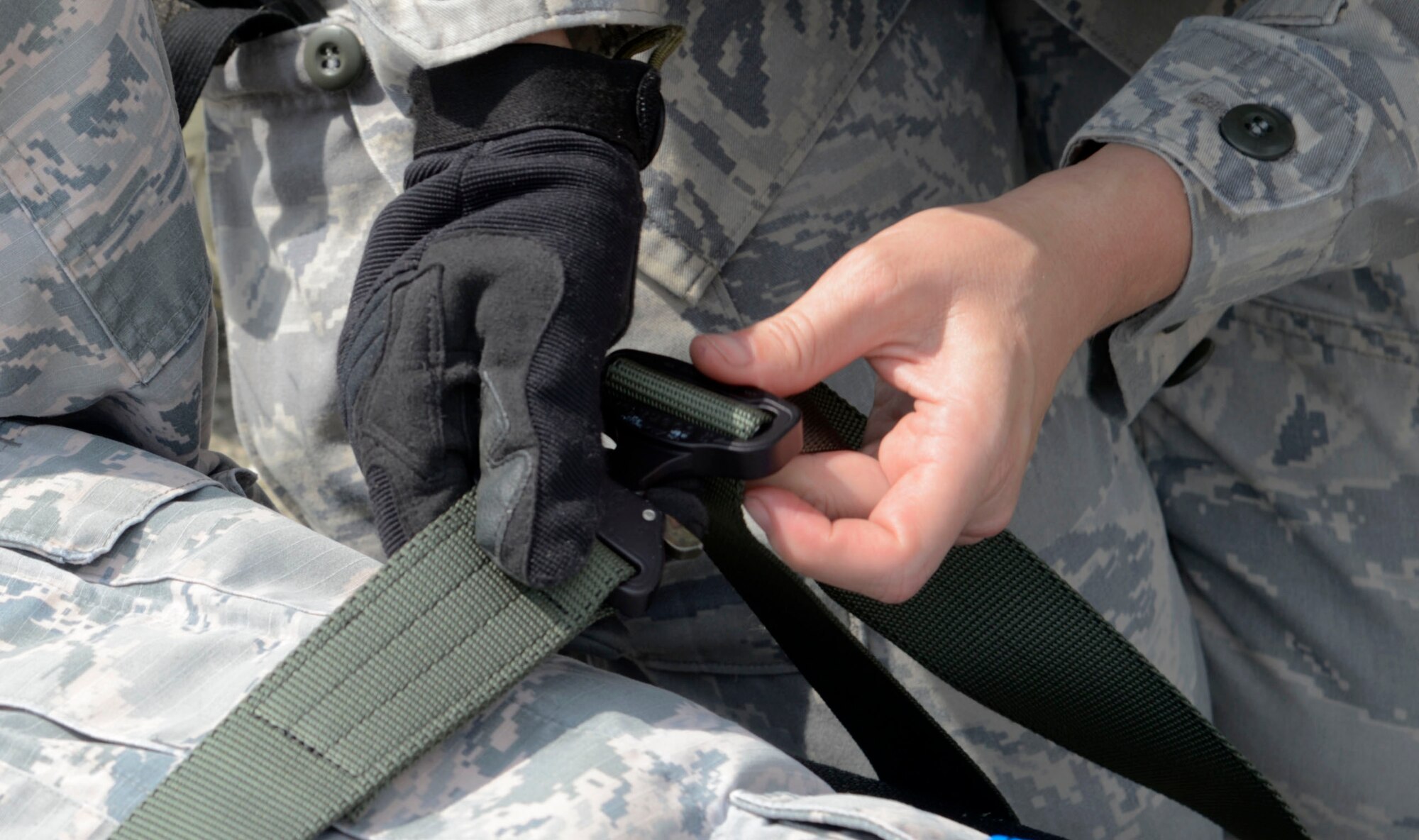 An Airman from the 6th Medical Group secures a patient on a litter during an aeromedical evacuation exercise at MacDill Air Force Base, Fla., March 12, 2017. Patients needed to be secured properly to ensure they can be safely transported out of a danger zone. (U.S. Air Force photo by Senior Airman Tori Schultz)