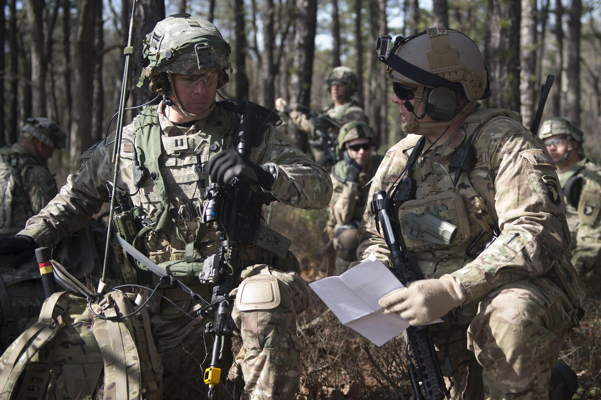 U.S. Air Force Maj. Ryan Schenk, 621st Mobility Support Operations Squadron air mobility liaison officer assigned to the 101st Airborne Division at Fort Campbell, Ky., reviews the transfer of authority checklist with U.S. Army Capt. Travis Seale, a 101st Abn. Div. soldier, while waiting for the airfield to be cleared during a mobility exercise called WAREX at Joint Base McGuire-Dix-Lakehurst, N.J., March 13, 2017. AMLOs advise supported units on safe, effective use of air mobility assets from the tactical to strategic level, bridge the communication gap between supported units and U.S. Air Force air mobility command and control agencies, conduct landing zone feasibility analyses, act as landing zone safety officers, and liaison between supported units and deployed mobility forces to ensure supported unit objectives are met. (U.S. Air Force photo by Tech. Sgt. Gustavo Gonzalez/RELEASED)