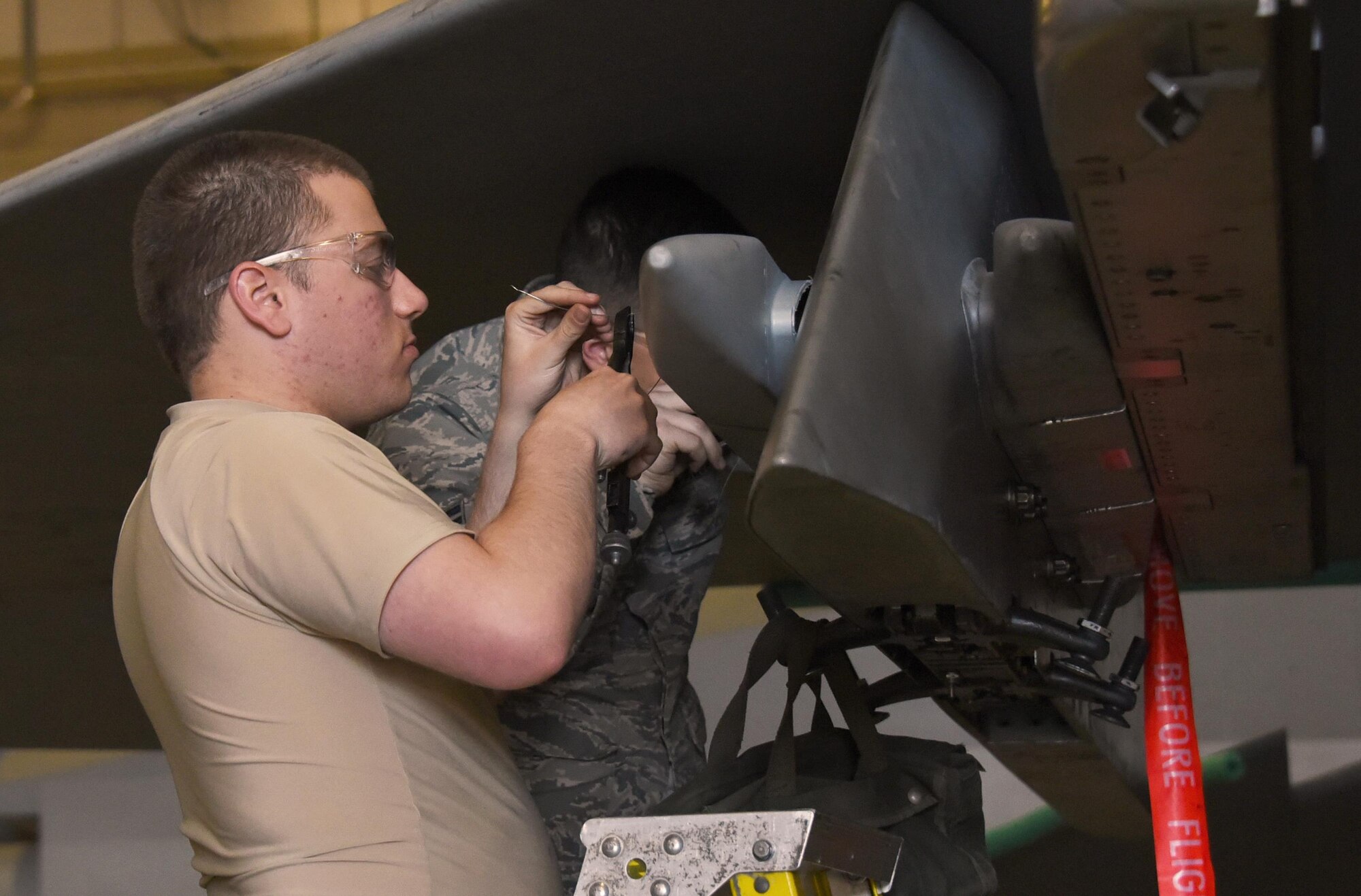 Airman 1st Class Joseph Limoli, 363rd Training Squadron F-15 Eagle armament student, safety wires the bolts on an ADU-552 missile launcher adapter. The wire is an extra safety measure that ensures the bolt doesn’t loosen up and fall out in flight. (U.S. Air Force photo by Liz H. Colunga/Released)