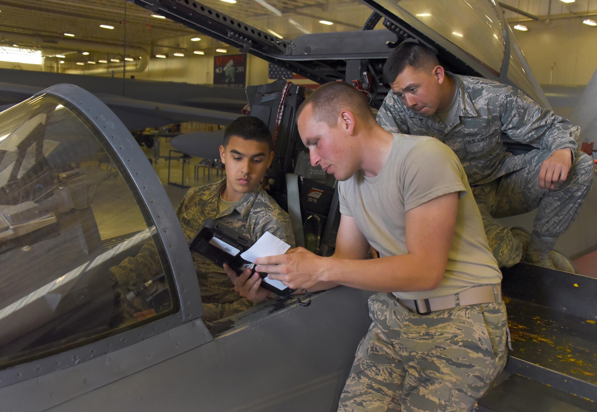 Airmen Michael Alejo, Dyllan Galloway and Jacob Ramirez, 363rd Training Squadron F-15 Eagle aircraft armament systems apprentice students, learn how to apply and remove external electrical power to and from the aircraft, March 2, 2017. This is the first step in learning to perform operations check on the weapons systems of the F-15 Eagle aircraft. (U.S. Air Force photo by Liz H. Colunga/Released)