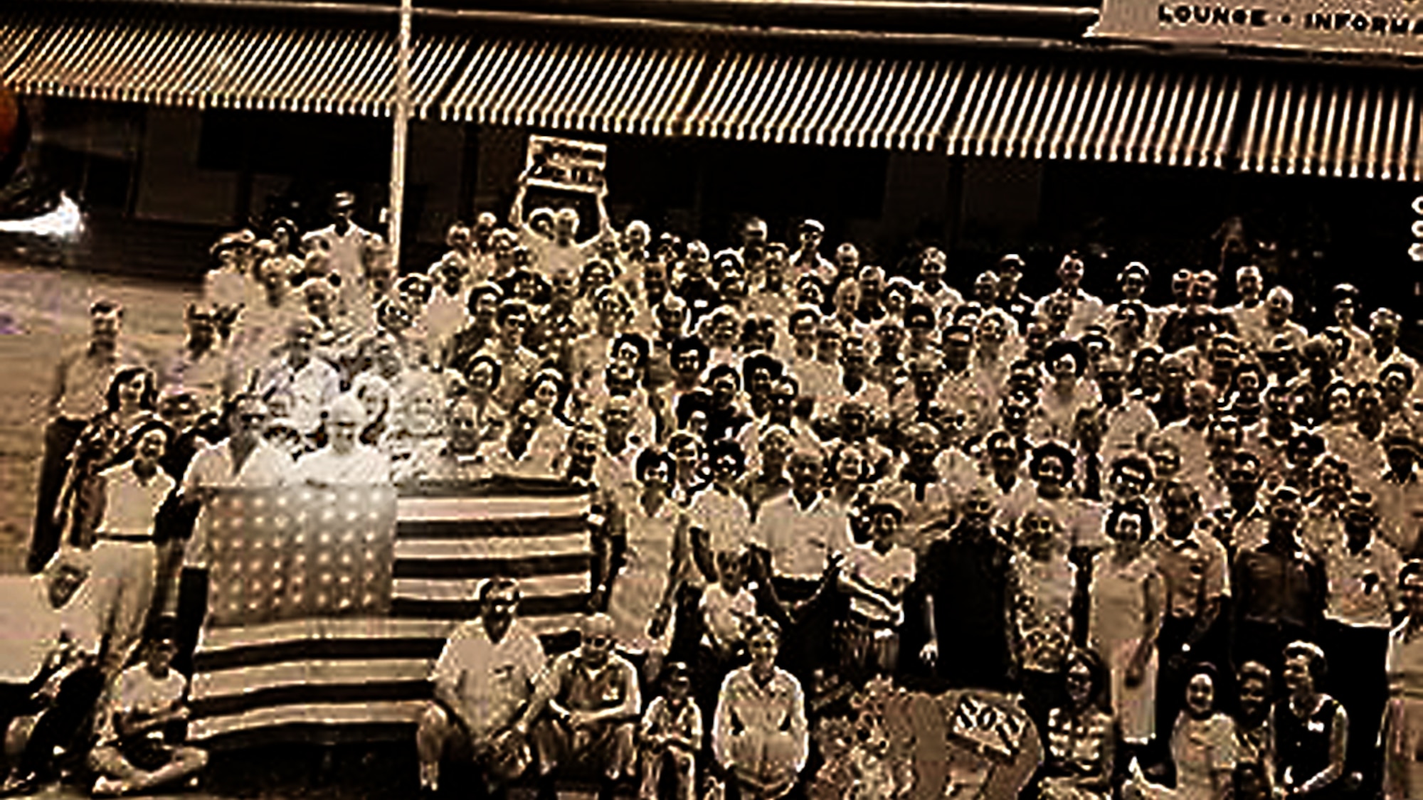 Retired Master Sgt. Francis M. Bania holds the U.S. flag during a Bataan Death March survivor reunion that is held annually. (U.S. Air Force illustration/Staff Sgt. Alexandre Montes)