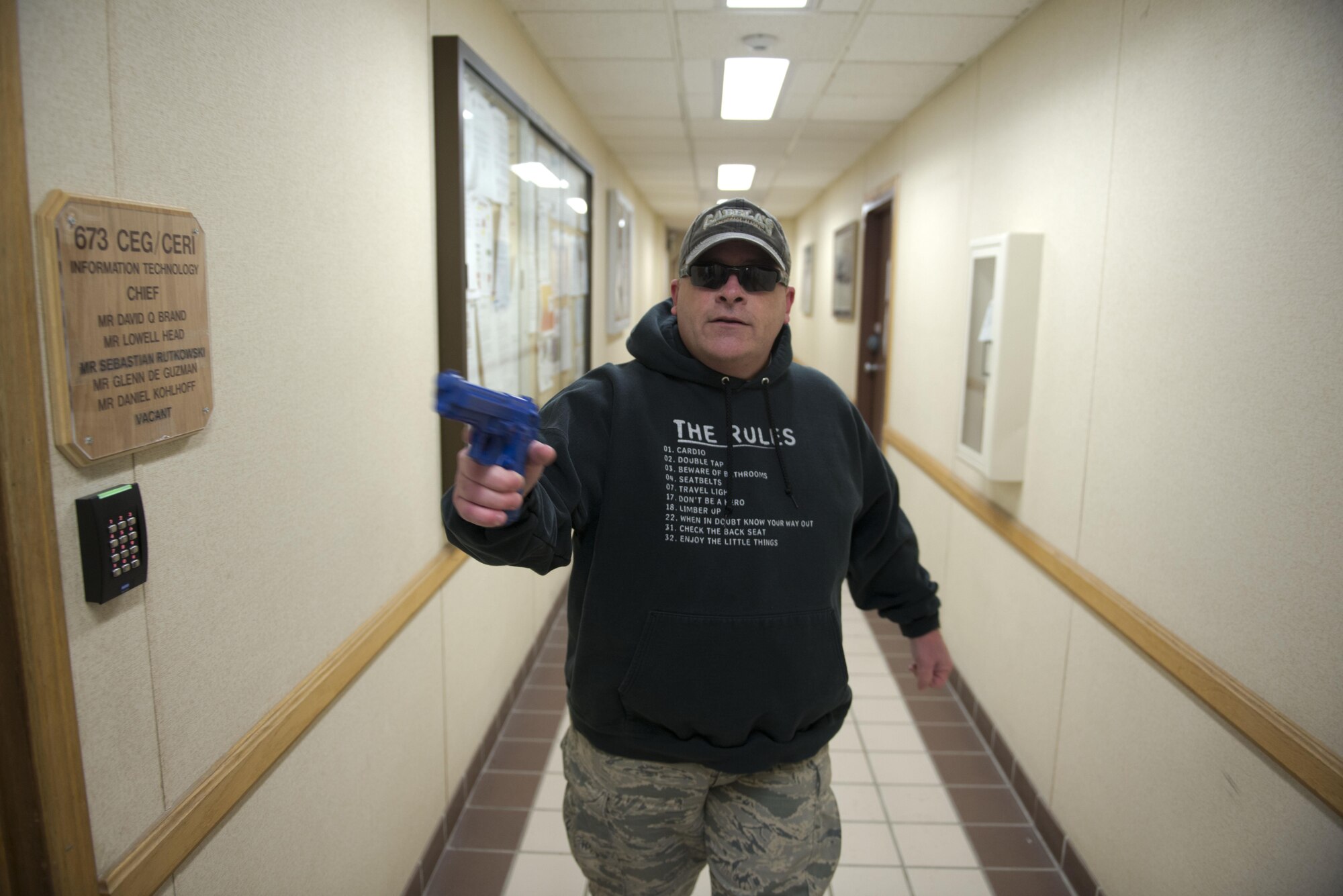 Air Force Master Sergeant Daniel Chrisco, an active shooter exercise player searches the halls of the 773rd Civil Engineer Squadron for unlocked office doors during an exercise March 13. The Security Forces Squadron on Joint Base Elmendorf-Richardson conducts regular no-notice tests of offices’ active shooter mentalities around base.