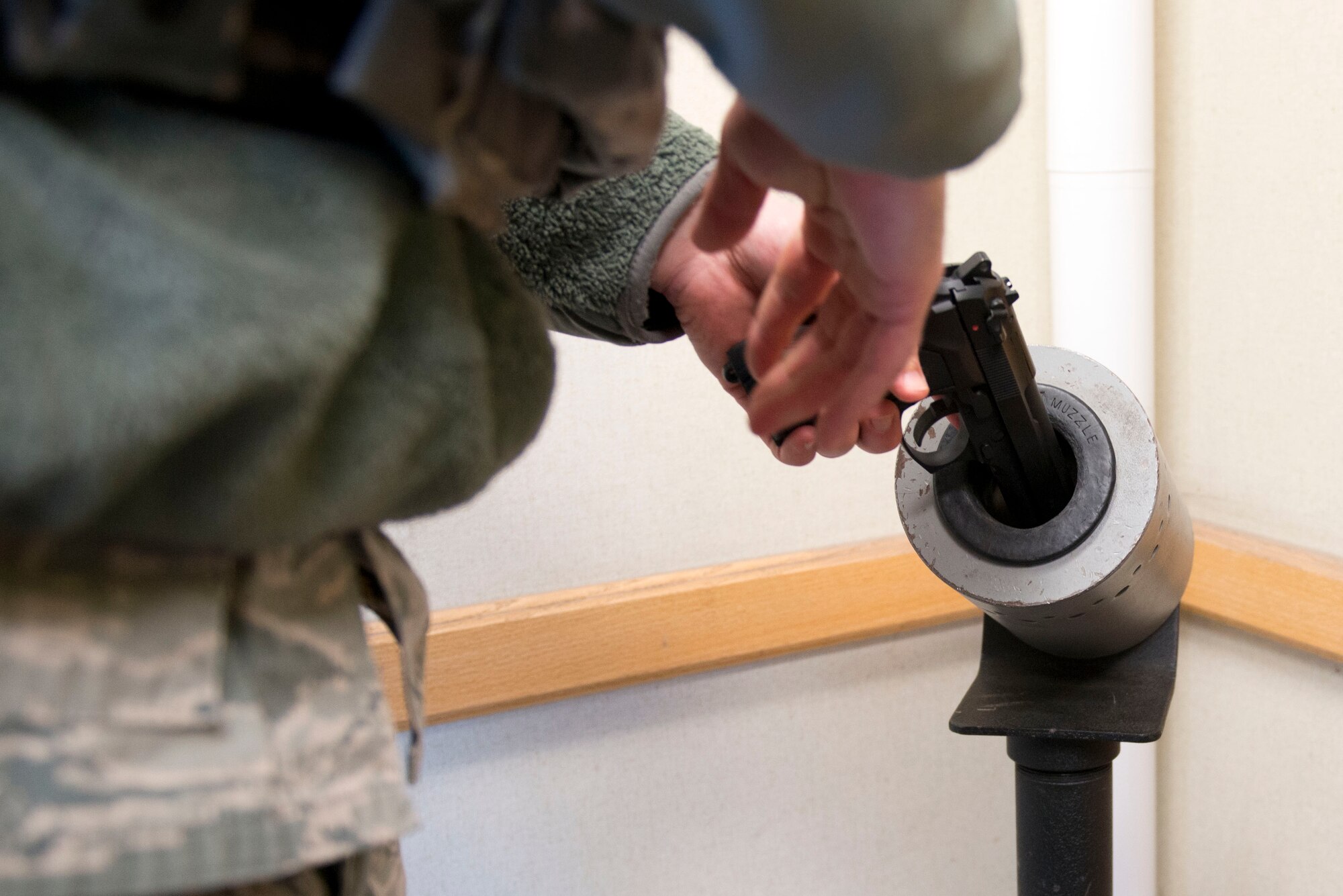 Air Force Staff Sgt. Nicholas Woolridge, a patrolman with the 673d Security Forces Squadron clears his firearm in the 773rd Civil Engineer Squadron, before beginning an active shooter detainment exercise, March 13. The Security Forces Squadron on Joint Base Elmendorf-Richardson conducts regular no-notice tests of offices’ active shooter mentalities around base.