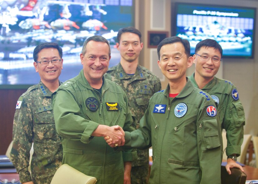 Republic of Korea Air Force Brig. Gen. Yoon Byung Ho (left), ROKAF Headquarters Office of Policy chief, greets U.S. Navy Rear Adm. Mathias Winter, F-35 Lightning II Joint Progam Office deputy program executive officer, during the Pacific F-35 Symposium at Joint Base Pearl Harbor-Hickam, Hawaii, March 15, 2017. The symposium is a Pacific Air Forces-hosted event that brings together the four Pacific members of the F-35 program: Japan, Australia, the Republic of Korea and the U.S. While attending the event, senior officers, warfighters and F-35 experts discussed a range of topics related to integrating the F-35 into multilateral air operations in the Indo-Asia-Pacific. The U.S. currently flies the F-35B out of Marine Corps Air Station Iwakuni, Japan, and is scheduled to field two additional squadrons at Eielson AFB, Alaska, starting in 2020. Australia and Japan are already flying their own F-35s and the ROK is projected to receive its first in 2018. (U.S. Air Force photo by Tech. Sgt. James Stewart)