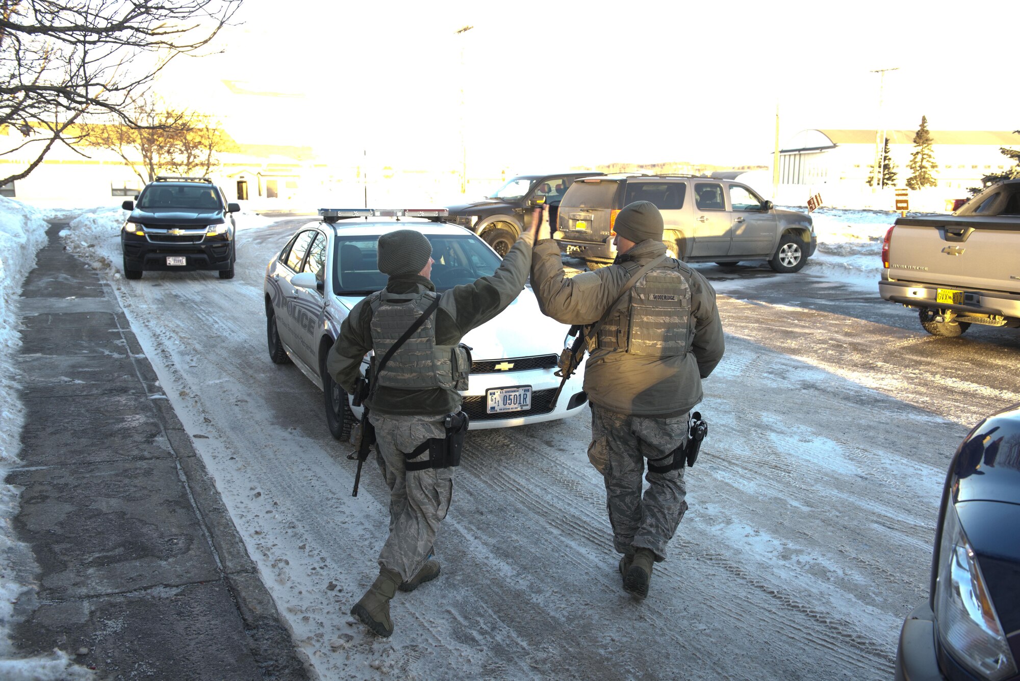 Air Force Staff Sgts Brittney Howard and Nicholas Woolridge, 673d Security Forces patrolmen, give each other a high-five after successfully detaining an active shooter player in the 773rd Civil Engineer Squadron, March 13. The Security Forces Squadron on Joint Base Elmendorf-Richardson conducts regular no-notice tests of offices’ active shooter mentalities around base.