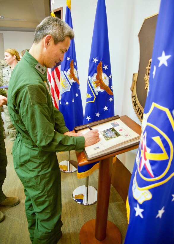 Koku-Jieitia (Japan Air Self-Defense Force) Maj. Gen. Koji Imaki, 3rd Air Wing commander, signs Pacific Air Forces' guest book during the Pacific F-35 Symposium at Joint Base Pearl Harbor-Hickam, Hawaii, March 15, 2017. The symposium is a PACAF-hosted event that brings together the four Pacific members of the F-35 program: Japan, Australia, the Republic of Korea and the U.S. While attending the event, senior officers, warfighters and F-35 experts discussed a range of topics related to integrating the F-35 into multilateral air operations in the Indo-Asia-Pacific. The U.S. currently flies the F-35B out of Marine Corps Air Station Iwakuni, Japan, and is scheduled to field two additional squadrons at Eielson AFB, Alaska, starting in 2020. Australia and Japan are already flying their own F-35s and the ROK is projected to receive its first in 2018. (U.S. Air Force photo by Tech. Sgt. James Stewart)