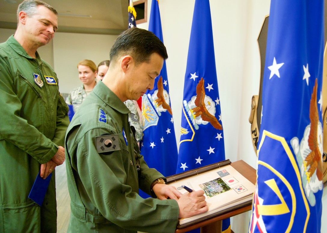 Republic of Korea Air Force Brig. Gen. Yoon Byung Ho, ROKAF Headquarters Office of Policy chief, signs Pacific Air Forces' guest book during the Pacific F-35 Symposium at Joint Base Pearl Harbor-Hickam, Hawaii, March 15, 2017. The symposium is a PACAF-hosted event that brings together the four Pacific members of the F-35 program: Japan, Australia, the Republic of Korea and the U.S. While attending the event, senior officers, warfighters and F-35 experts discussed a range of topics related to integrating the F-35 into multilateral air operations in the Indo-Asia-Pacific. The U.S. currently flies the F-35B out of Marine Corps Air Station Iwakuni, Japan, and is scheduled to field two additional squadrons at Eielson AFB, Alaska, starting in 2020. Australia and Japan are already flying their own F-35s and the ROK is projected to receive its first in 2018. (U.S. Air Force photo by Tech. Sgt. James Stewart)