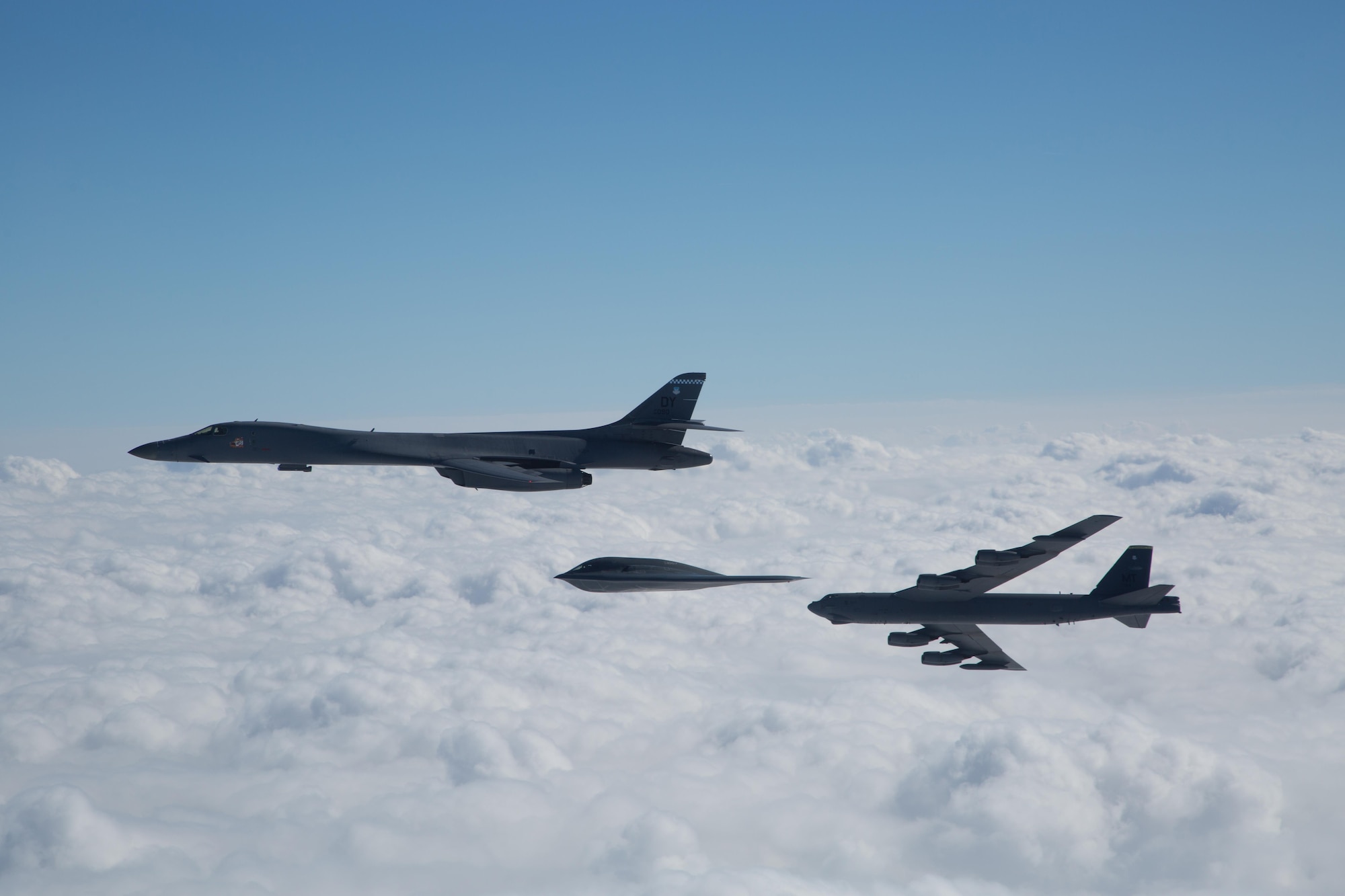 A three-ship bomber formation composed of a B-1B Lancer, B-2 Spirit and B-52 Stratofortress fly near Barksdale Air Force Base, La., Feb. 2, 2017. The bombers participated in an in-trail formation flyover to honor and commemorate the Eighth Air Force’s 75th anniversary. (U.S. Air Force courtesy photo by Sagar Pathak)	