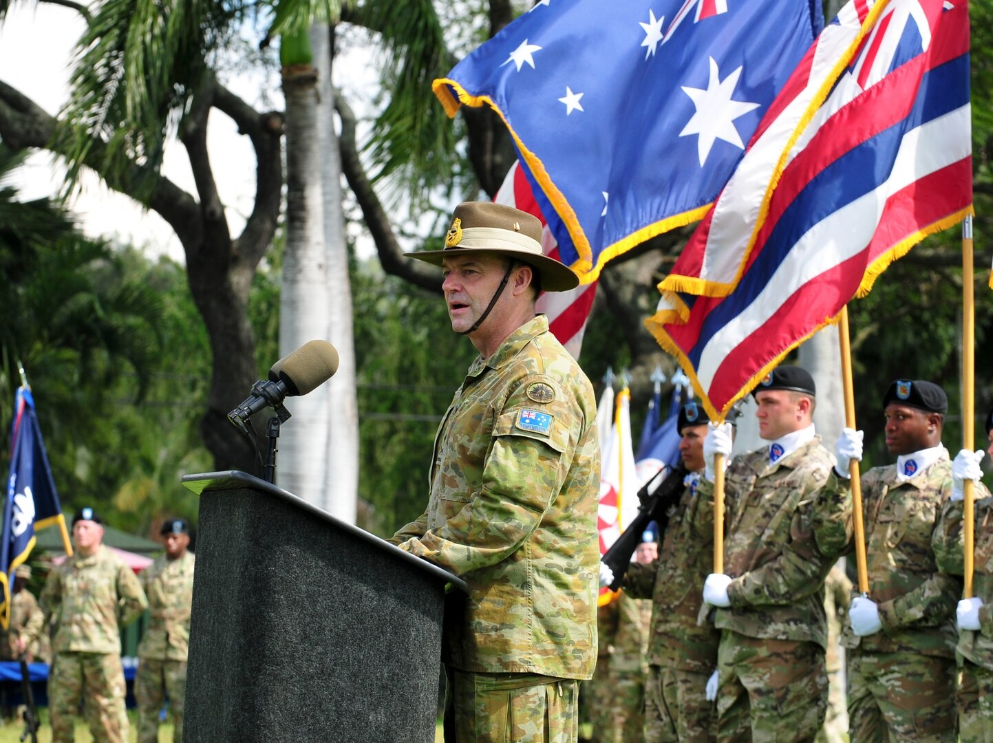 Australian Army Maj. Gen. Gregory C. Bilton, outgoing Deputy Commanding General-North, U.S. Army Pacific, delivers his speech during at a Flying "V" ceremony held at historic Palm Circle, Fort Shafter, Mar. 14, 2016.  The Flying "V" ceremony was held to honor Bilton for his distinguished service as Deputy Commanding General-North, U.S. Army Pacific, as he prepares to depart USARPAC; and to welcome Brig. Gen. Doug Anderson (not pictured), incoming Deputy Commanding General-Army Reserve. The "V" refers to the way the colors are posted during the ceremony, which is V-shaped. 