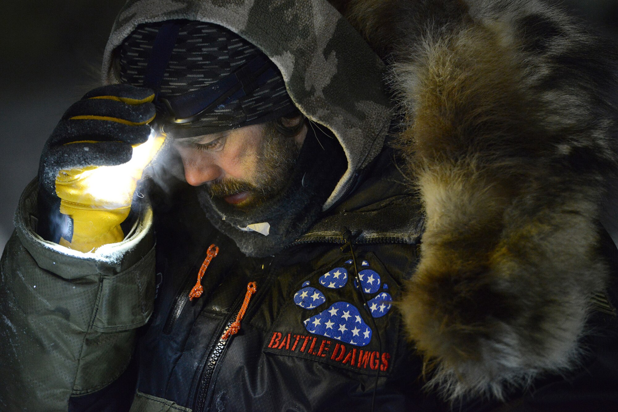 Rick Casillo, Battle Dogs founder and Iditarod Trail Sled Dog Race veteran, checks his headlamp in Nome, Alaska, March 15, 2017. Casillo has been racing since 2004 and in 2012, he and his wife, Air Force Lt. Col. Jennifer Casillo, Alaska Air National Guard 176th Rescue Wing aircraft maintenance operations flight commander, created Battle Dogs to help combat veterans.