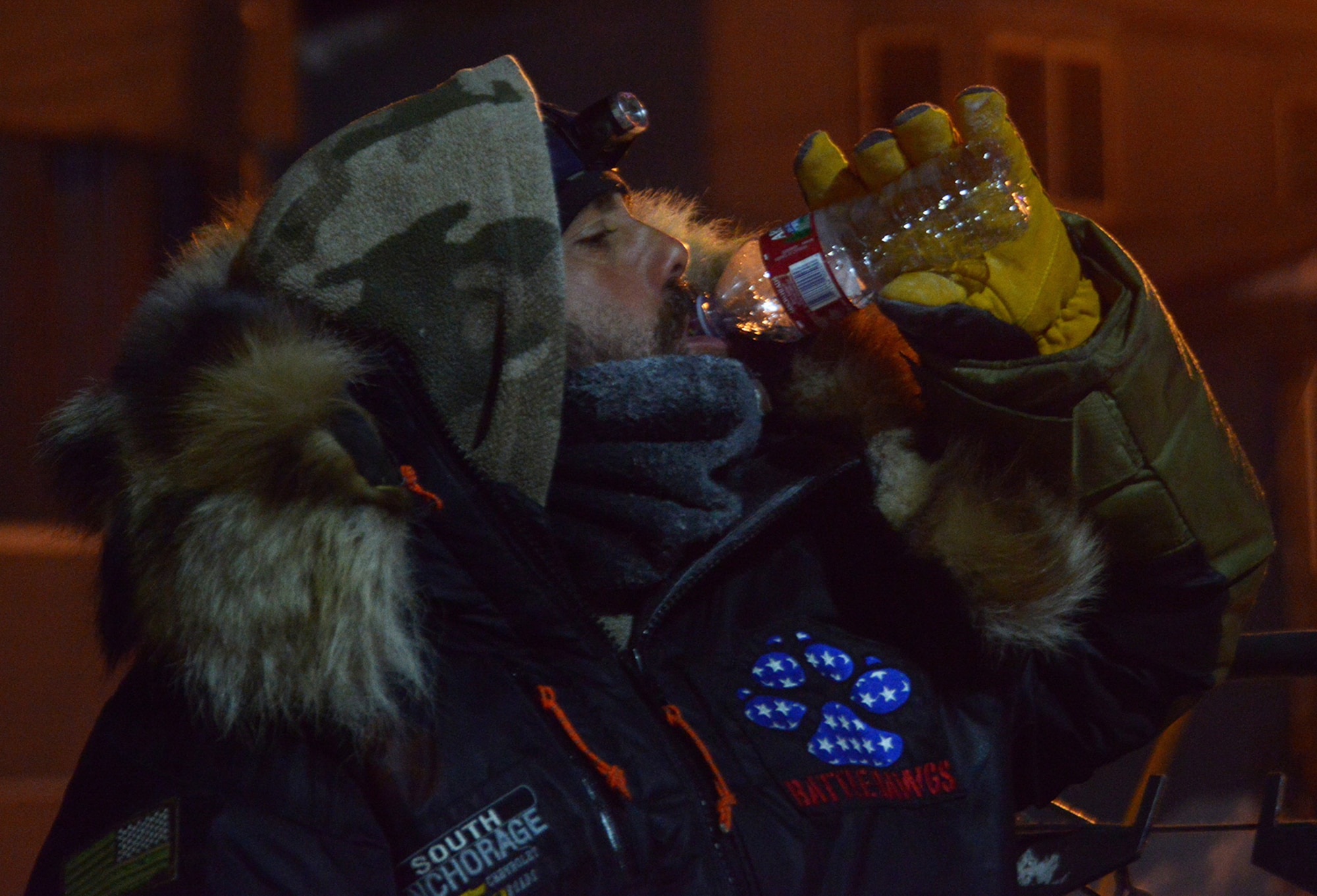 Rick Casillo, Battle Dogs founder and Iditarod Trail Sled Dog Race veteran, drinks water after placing 28th in Nome, Alaska, March 16, 2017.  The Iditarod is an annual 1,000-mile race challenging mushers and dog teams alike under cold weather conditions and long distance travel to the finish line in Nome. 