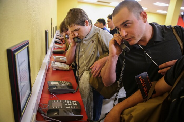 Recruits from Echo Company, 2nd Recruit Training Battalion, make their phone calls home, reading only what is printed on the script in front of them, during receiving at Marine Corps Recruit Depot San Diego, March 13. Recruits will not be able to make another phone call until the end of recruit training. Annually, more than 17,000 males recruited from the Western Recruiting Region are trained at MCRD San Diego. Echo Company is scheduled to graduate June 9.