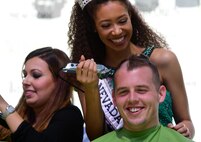 Miss Nevada Teen USA Alexis Smith, shaves 2nd Lt. Kyle’s hair for a fundraiser, March 11, 2017, in Las Vegas. Kyle is a 15th Attack Squadron MQ-1 Predator pilot. He and other members of his unit shaved their heads in support of children who have been diagnosed with cancer. (U.S. Air Force photo/Senior Airman Christian Clausen)