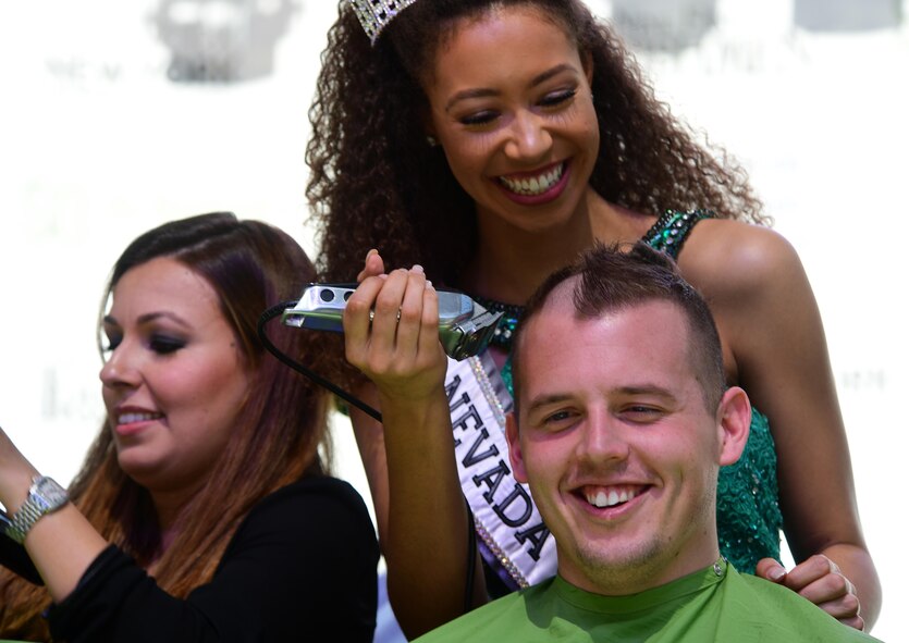 Miss Nevada Teen USA Alexis Smith, shaves 2nd Lt. Kyle’s hair for a fundraiser, March 11, 2017, in Las Vegas. Kyle is a 15th Attack Squadron MQ-1 Predator pilot. He and other members of his unit shaved their heads in support of children who have been diagnosed with cancer. (U.S. Air Force photo/Senior Airman Christian Clausen)