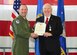 Brig. Gen. (sel) Gentry Boswell, 28th Bomb Wing commander, presents Al Cornella with the Air Force Distinguished Public Service Award during a Military Affairs Committee meeting at Ellsworth Air Force Base, S.D., on March 16, 2017. Cornella received the award, the highest given to non-Department of Defense civilians by the Secretary of Defense, by advocating for the Air Force, connecting regional and professional communities to the service and bolstering a better understanding of the military. (U.S. Air Force photo by Airman 1st Class Randahl J. Jenson) 