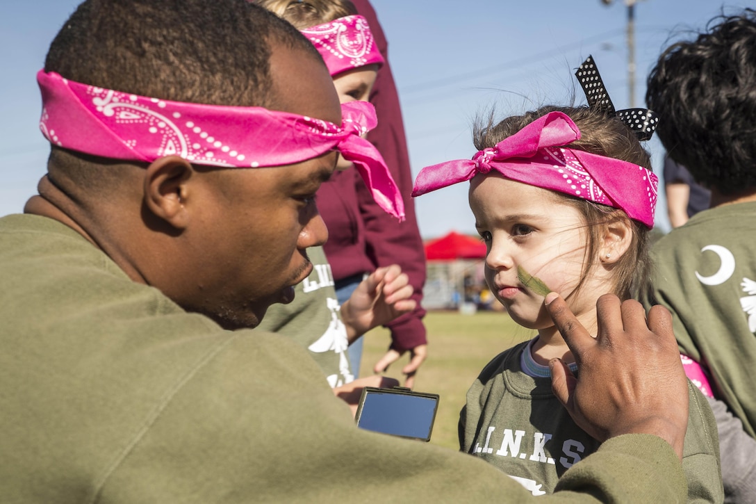 A Marine paints a child’s face during a "Mini Marines" event for military children at Marine Corps Air Station Beaufort, S.C., March 11, 2017. Marine Corps photo by Lance Cpl. Ashley Phillips