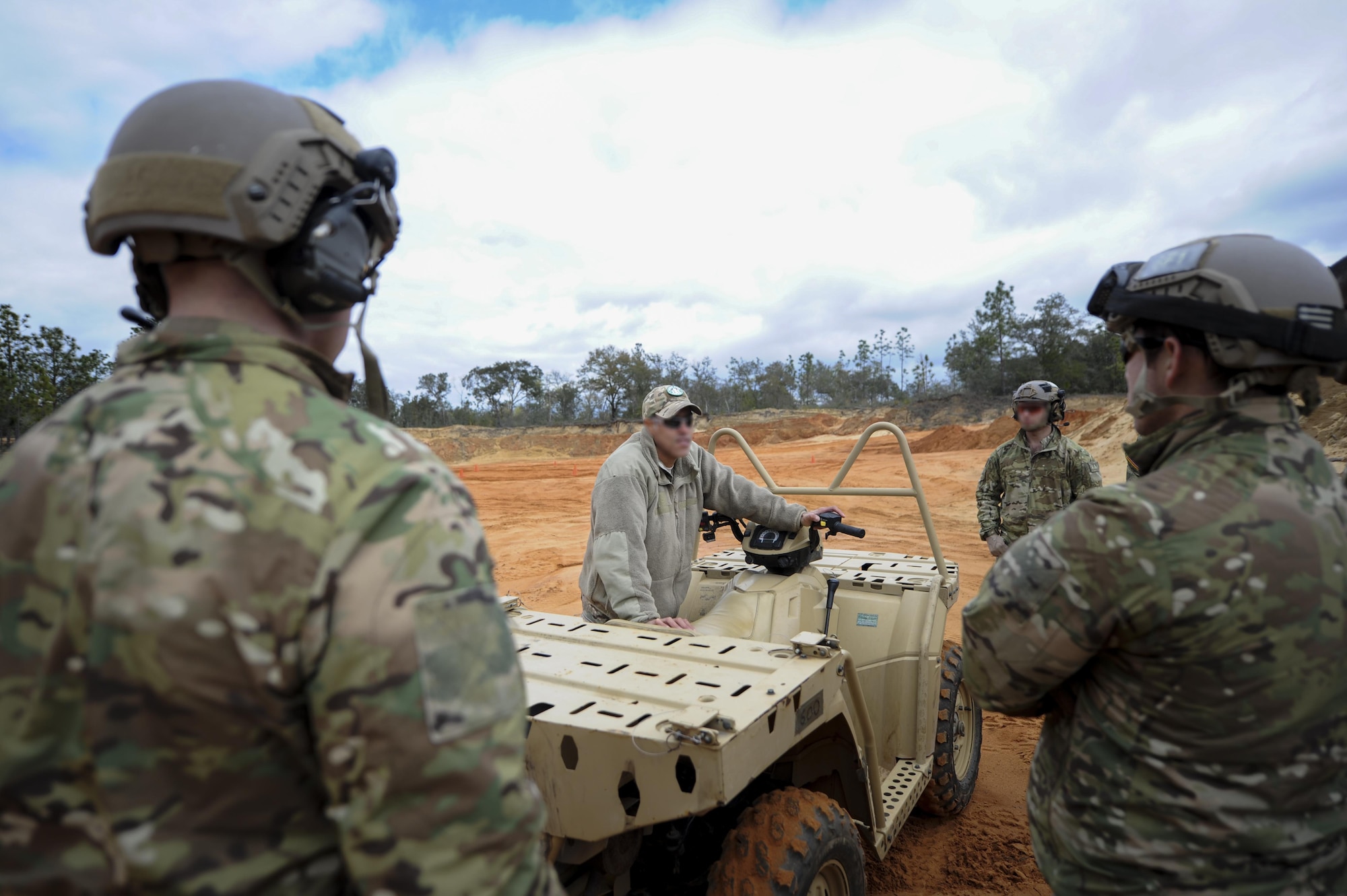 An instructor with the 1st Special Operations Support Squadron Operational Support Joint Office, briefs a team of Soldiers on various all-terrain vehicle operations at Buck Pond in Navarre, Fla., March 14, 2017. The 1st SOSS/OSJ instructor taught a team from the 1st Battalion, 10th Special Forces Group, how to safely turn by adjusting body weight, how to stop properly and how to safely climb a hill. (U.S. Air Force photo by Airman 1st Class Dennis Spain)