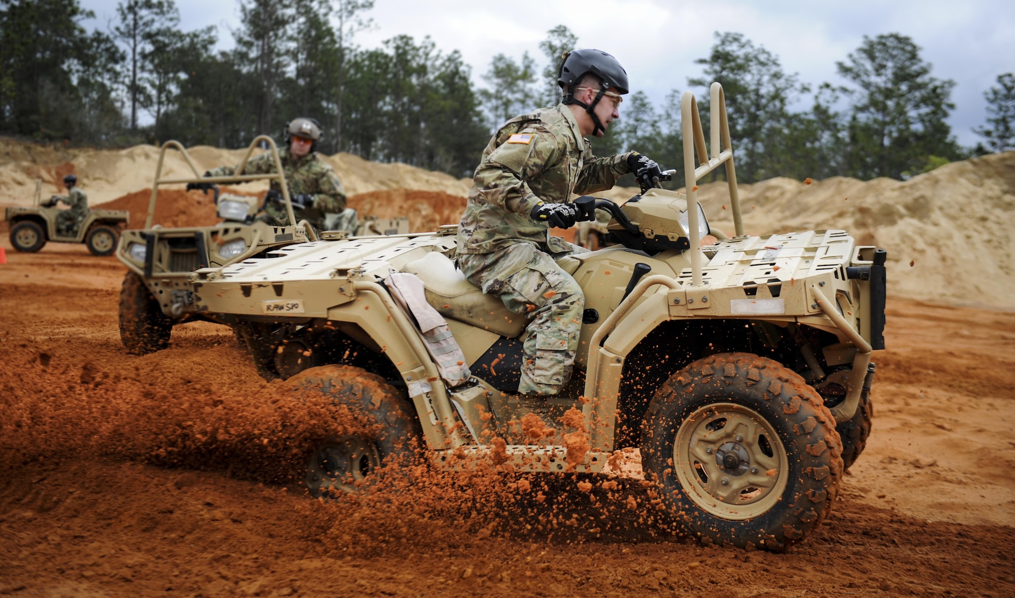 A Soldier with the 1st Battalion, 10th Special Forces Group, executes a sharp turn in an all-terrain vehicle at Buck Pond in Navarre, Fla., March 14, 2017. An instructor with the 1st Special Operations Support Squadron Operational Support Joint Office trained Soldiers on riding techniques to qualify them for ATV usage in special operations missions. (U.S. Air Force photo by Airman 1st Class Dennis Spain)