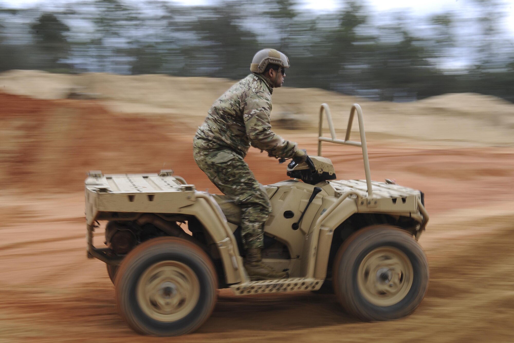 A Soldier with the 1st Battalion, 10th Special Forces Group, rides an all-terrain vehicle at Buck Pond in Navarre, Fla., March 14, 2017. An instructor from the 1st Special Operations Support Squadron Operational Support Joint Office taught Soldiers ATV techniques such as weight placement during a turn, how to stop properly and how to safely climb a hill. (U.S. Air Force photo by Airman 1st Class Dennis Spain)